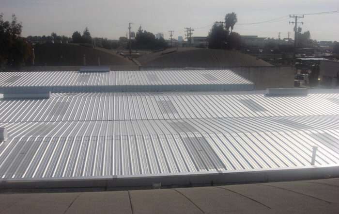 New fiberglass skylights and ridge vents installed with new metal roofing