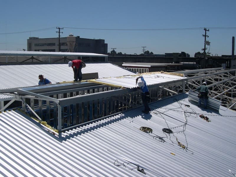 Skilled metal building contractors assembling a steel structure